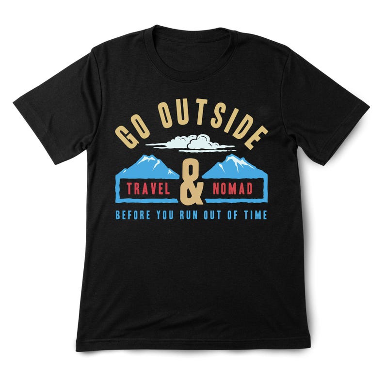 May include: Black t-shirt with a graphic design. The design features the words "GO OUTSIDE" above a mountain scene with the words "TRAVEL & NOMAD" and the phrase "BEFORE YOU RUN OUT OF TIME".