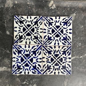 May include: A set of three ceramic mugs with a speckled, matte finish. The mugs are in shades of cream, light gray, and dark gray. Each mug has a simple, minimalist design and a rounded handle.