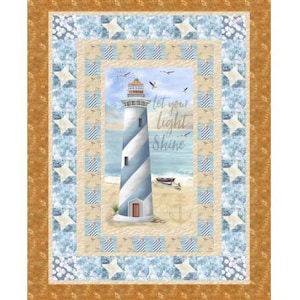 May include: A nautical-themed quilt featuring a lighthouse with blue and white stripes, set against a beach scene. The quilt has a border with star and floral patterns, and the text "Let Your Light Shine".