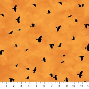 May include: Orange fabric with a pattern of black birds in flight. The birds are silhouetted against a textured, sunset-colored background. The fabric is suitable for various craft projects.