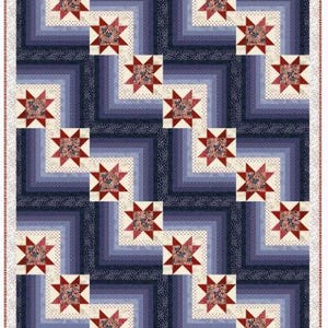 May include: A patriotic quilt featuring a repeating pattern of red, white, and blue stars and stripes. The quilt has a layered design with a white dotted border and a mix of light and dark blue squares. The stars are a deep red color.
