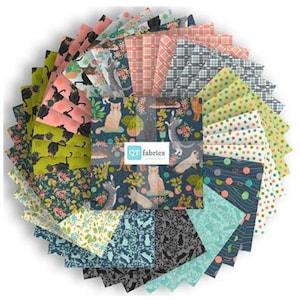May include: A circular stack of fabric squares in various patterns and colors. The fabrics feature designs of cats, umbrellas, floral prints, and polka dots. The center fabric square has the text "QT fabrics".