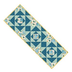 May include: A rectangular quilted table runner with a geometric pattern in shades of teal, light blue, and white. The design features squares and triangles, with floral accents and a gold border. The runner is approximately 60 inches long.