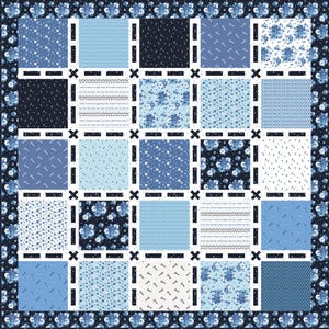 May include: A patchwork quilt in shades of blue and white, featuring various patterns like floral, geometric, and dotted designs. The quilt has a dark blue floral border and is composed of square blocks separated by white lines and black crosses.
