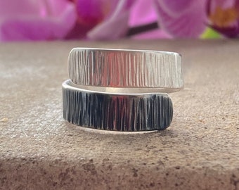 Handmade partially oxidised sterling silver adjustable wrap textured ring.