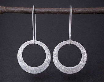 Circle dangle earrings with textured finish.