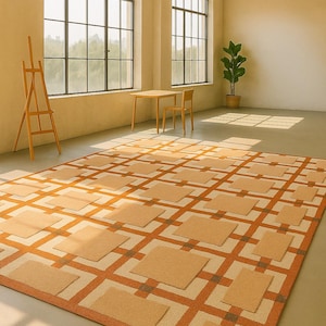 May include: A large, rectangular area rug with a geometric pattern of squares and lines in shades of orange, beige, and brown. The rug is placed in a room with large windows, a wooden table, and a chair.