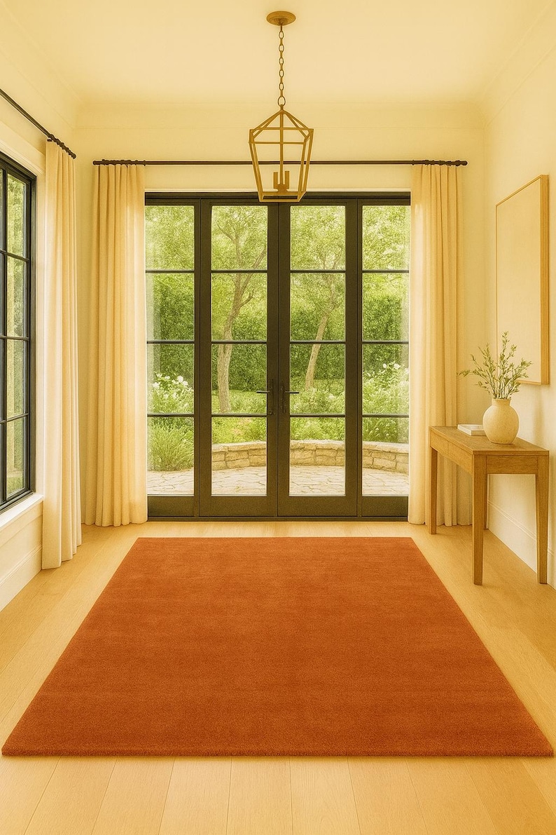 Soft hand-tufted terracotta rug styled in cozy bedroom