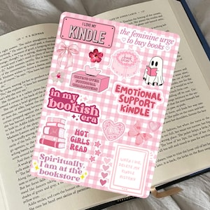 Pode incluir: Folha de adesivos xadrez rosa e branco com vários designs, incluindo texto como "I Love My Kindle" e "Emotional Support Kindle". Apresenta laços, flores e um fantasma lendo um livro.