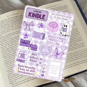 May include: A sticker sheet with a lilac gingham design, featuring stickers with phrases such as "I love my Kindle" and "The feminine urge to buy books." Includes floral and heart motifs.