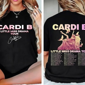 May include: Black t-shirt featuring the text "CARDI B LITTLE MISS DRAMA TOUR" in pink and white. The front of the shirt includes Cardi B's signature. The back of the shirt has a graphic of a woman and a list of tour dates.