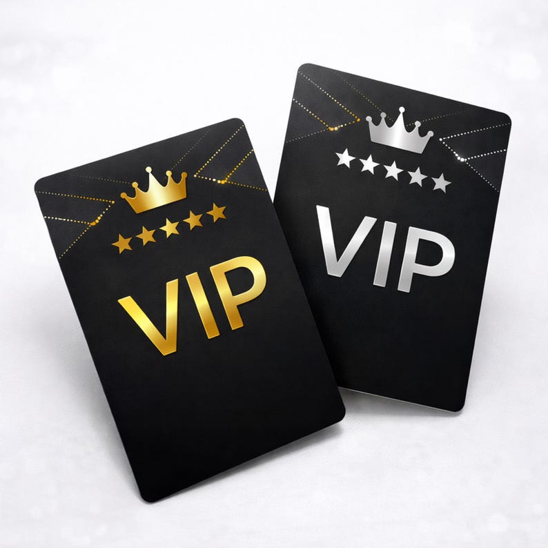 May include: Two rectangular black cards featuring the text VIP in large capital letters. One card displays a gold crown and five gold stars, while the other card features a silver crown and five silver stars. Both cards have geometric gold lines.