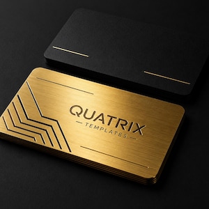 May include: A stack of rectangular business cards featuring a brushed gold metallic finish with the embossed text QUATRIX TEMPLATES and geometric chevron lines on the left side, paired with a stack of matte black cards with gold line accents.
