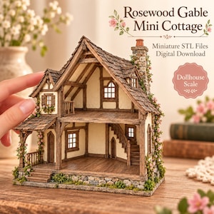 May include: A miniature two-story cottage model titled Rosewood Gable Mini Cottage, featuring a stone foundation, wooden timber framing, a shingled roof, a chimney, and climbing pink floral vines. The structure includes an open front design.
