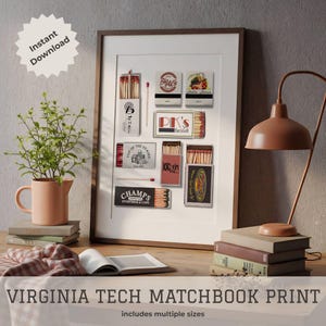 May include: A framed print featuring a collection of vintage matchboxes, including "Bigals" and "PK's Bar & Grill." The print is labeled "Virginia Tech Matchbook Print" and includes the text "Instant Download." The artwork is displayed on a wooden surface with a lamp and plant.
