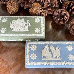 May include: A set of three ceramic mugs with a speckled, matte finish. The mugs are in shades of cream, light gray, and dark gray. Each mug has a simple, minimalist design, perfect for coffee or tea.