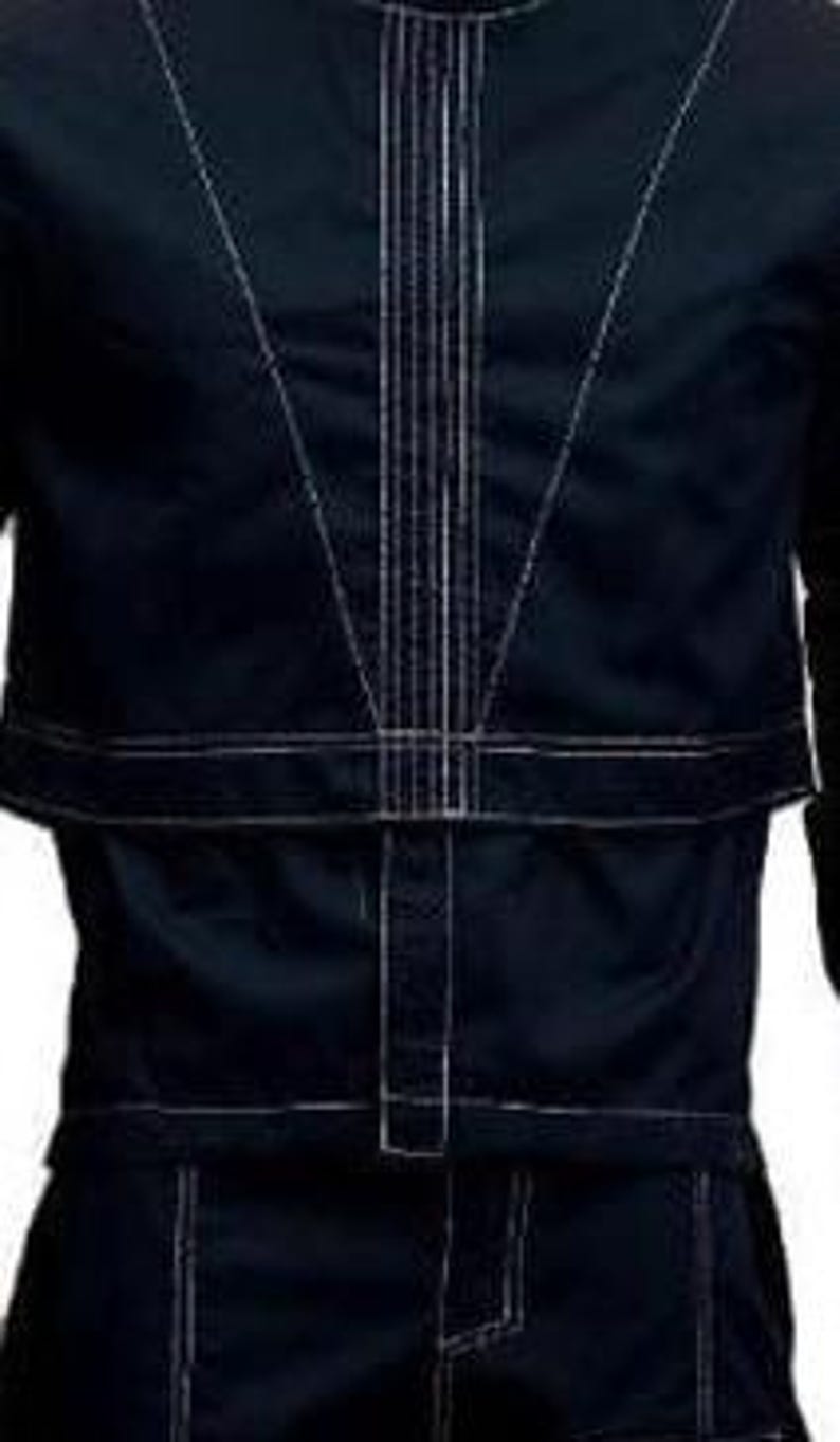 May include: A dark navy blue long-sleeve shirt featuring prominent white contrast stitching. The design includes a vertical panel down the centre chest, a horizontal seam across the midsection, and a V-shaped stitch pattern on the upper torso.