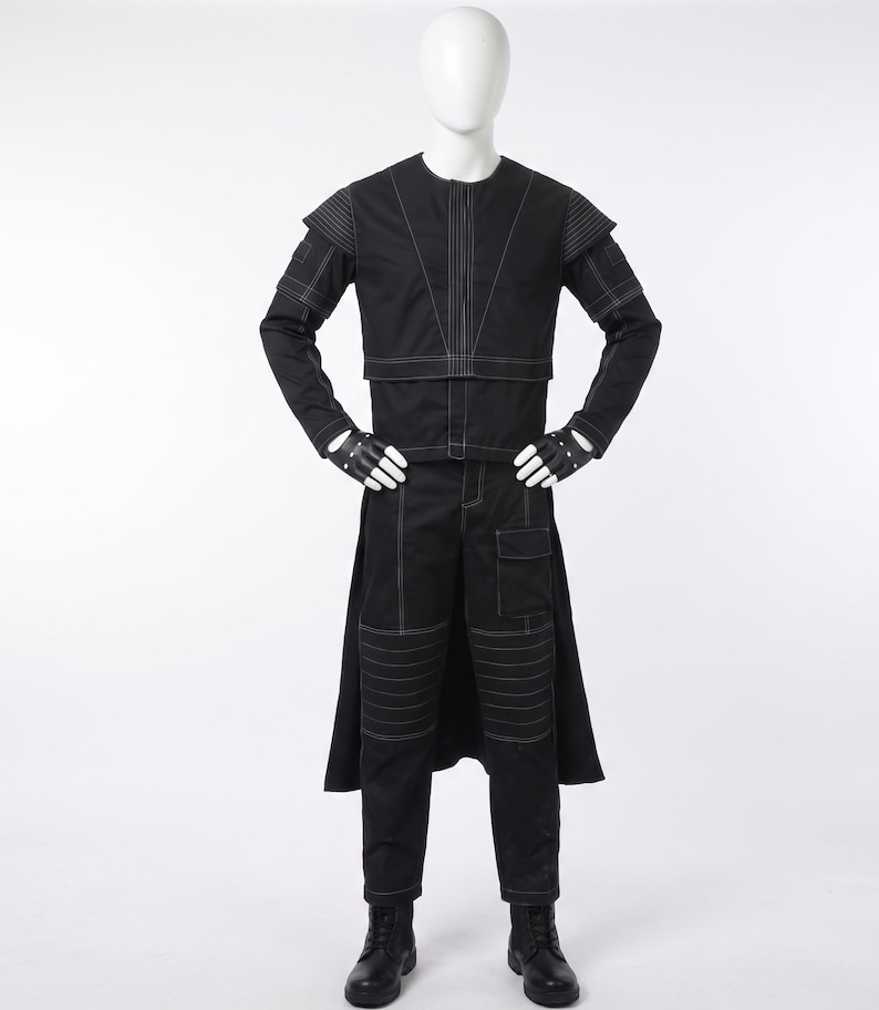 May include: A black long-sleeved jacket and matching trousers set featuring prominent white contrast stitching. The jacket has structured shoulders and a high neckline. The trousers include knee detailing and a side pocket. Black gloves and boots complete the outfit.