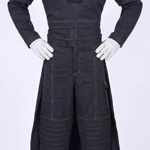 May include: A black long-sleeved top and matching trousers with white contrast stitching. The top features a V-shaped chest panel and shoulder detailing. The trousers include a belted waist, side pockets, and padded knee sections. White gloves and boots.