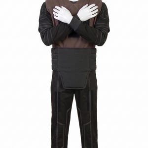 May include: A full-body costume on a mannequin. The costume includes a brown vest, a black long-sleeved shirt, a black belt, and black trousers. White stitching accents the seams of the clothing. The mannequin's arms are crossed over its chest.