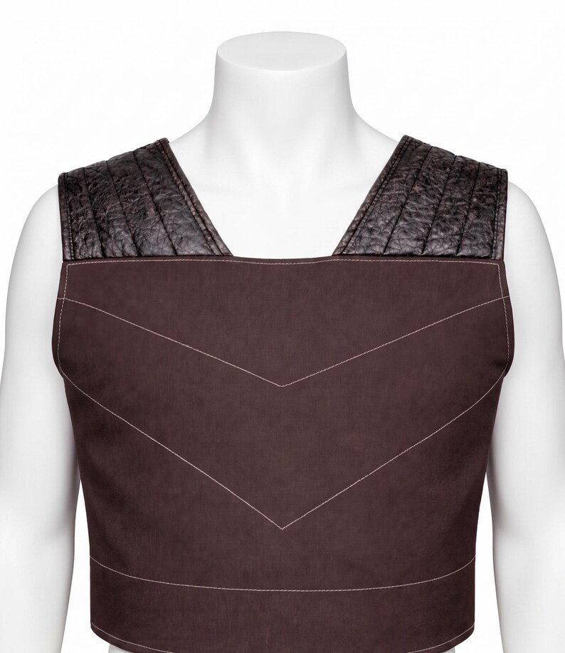 May include: A sleeveless dark brown vest featuring a smooth matte finish on the main body with white stitched chevron detailing. The shoulder panels are constructed from a textured black material with vertical quilted stitching patterns.