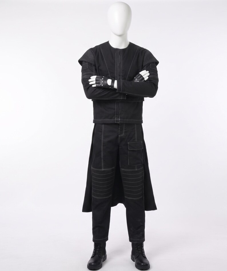 May include: A black long-sleeved jacket and matching trousers set featuring white contrast stitching, ribbed shoulder and knee panels, a flap pocket on the thigh, and a long back panel. The outfit includes black fingerless gloves and black boots.
