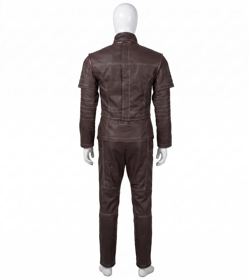 May include: A dark brown jacket and matching trousers set featuring a high collar, short sleeves with layered shoulder detailing, and prominent white topstitching throughout. The garment displays a structured design with horizontal paneling on the sleeves.