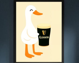 May include: Framed print of a cartoon duck with a pint of Guinness. The duck is white with an orange beak and feet. The Guinness glass is black with a white head and the Guinness logo.