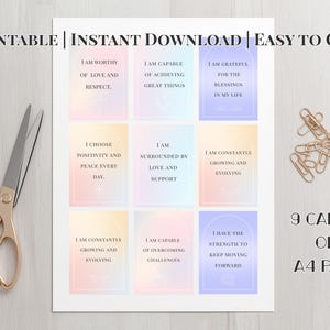 May include: Printable affirmation cards on an A4 page with gold scissors and paper clips. The cards have pastel backgrounds and inspirational text. The text includes phrases like "I am worthy" and "I am grateful".