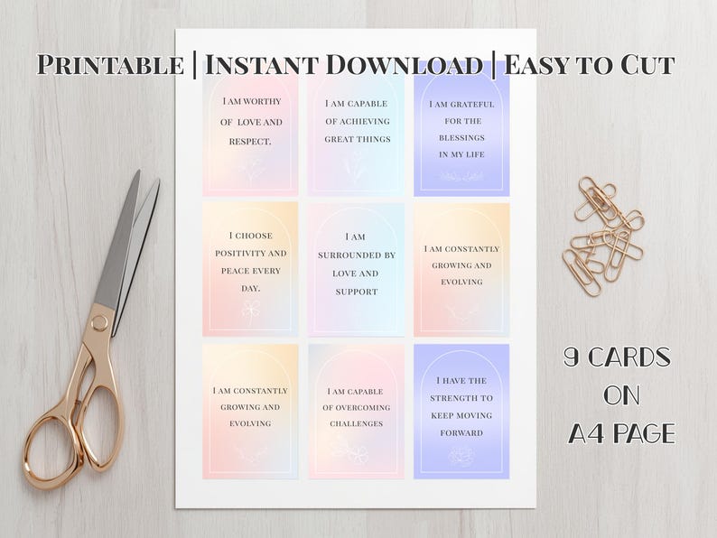 May include: Printable affirmation cards on an A4 page with gold scissors and paper clips. The cards have pastel backgrounds and inspirational text. The text includes phrases like "I am worthy" and "I am grateful".