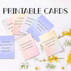 May include: Printable cards with affirmations in a variety of pastel colors. The cards feature phrases like "I release negativity and welcome positivity" and "I am constantly growing and evolving." The words "Printable Cards" are at the top.