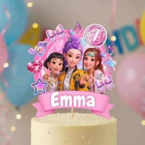 May include: A cake topper with three cartoon girls, the name "Emma" on a pink banner, musical notes, stars, bows, and a disco ball with the number 7. The cake has a light yellow frosting. A festive decoration for a birthday.