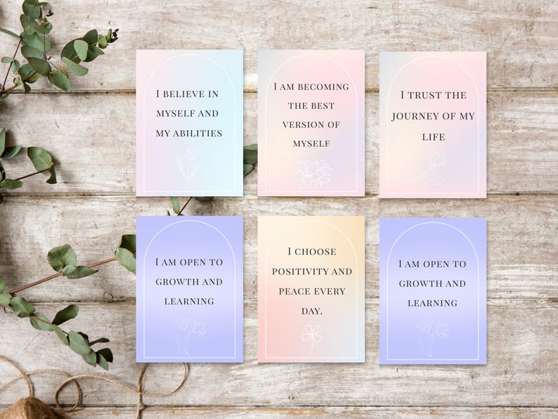 May include: Six affirmation cards with pastel gradient backgrounds and floral illustrations. Each card features a different positive affirmation in a white arch, such as "I believe in myself and my abilities."