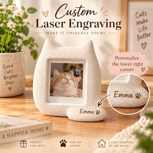 May include: A white, textured cat-shaped photo frame with a square opening. The frame features a custom laser engraving of the name Emma followed by a paw print icon. A photograph of a ginger cat is displayed inside the frame.