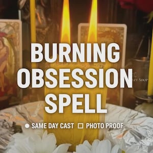 May include: A yellow pillar candle with two lit wicks, featuring the text BURNING OBSESSION SPELL, SAME DAY CAST, and PHOTO PROOF. The candle is surrounded by white daisy flowers with yellow centers, set against a background of tarot cards.