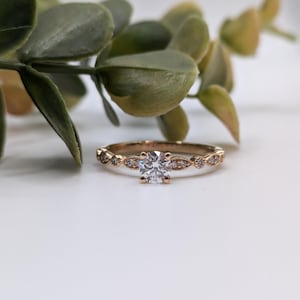 vintage style 18k rose gold diamond solitaire with unique diamond band