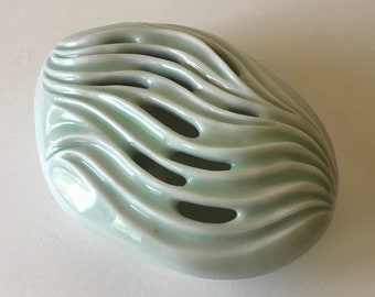 Porcelain pillow vase, glossy green celadon  glaze, carved curvy design