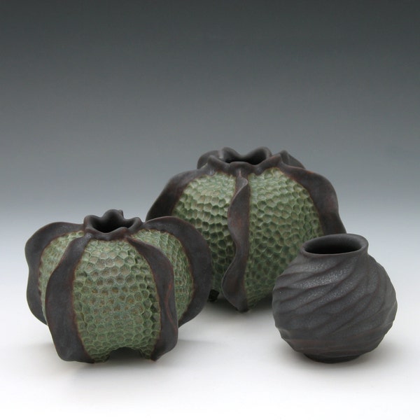 Carved porcelain urchin vessel, glazed in green & brown