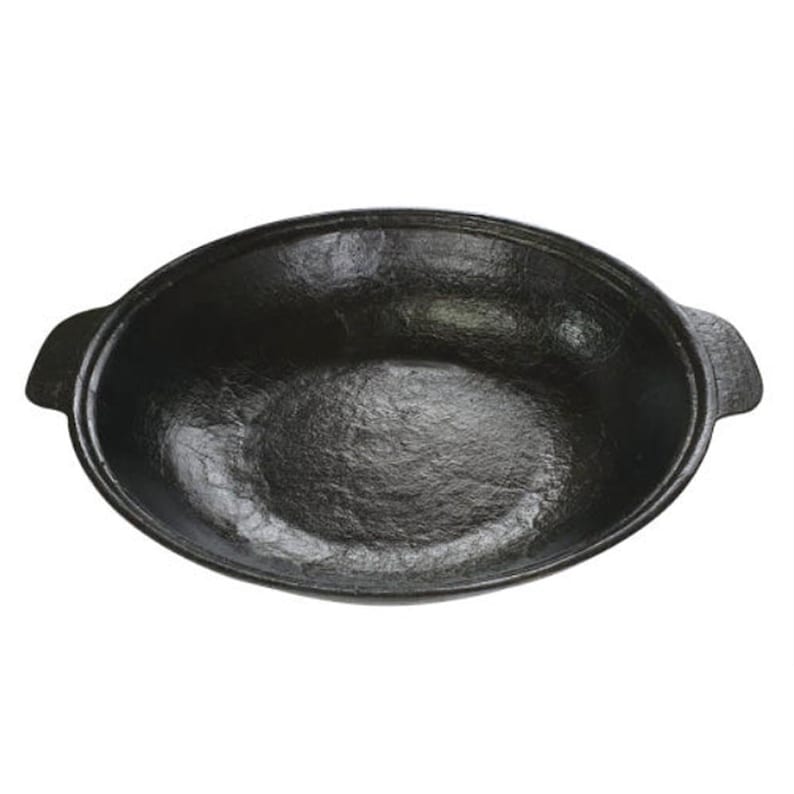 May include: A black, oval-shaped cast iron pan with two handles. The pan has a textured surface and a deep interior. The pan is designed for cooking and serving food. The pan is suitable for use on a stovetop or in an oven.