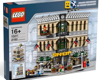 May include: A LEGO box set featuring the Grand Emporium building. The box shows a detailed three-story building with tan walls, green accents, and American flags. The set includes 2182 pieces and is for ages 16+.