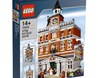 May include: LEGO set box featuring a detailed model of a multi-story building with a clock tower. The building is primarily brown and white with architectural details. The box includes the LEGO logo, the number 10224, and the age range 14+.