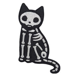 May include: Black cat patch with a skeleton design. The cat is sitting upright with its tail curled. The skeleton is white, and the cat's body is black. This patch is perfect for Halloween or gothic-themed projects.