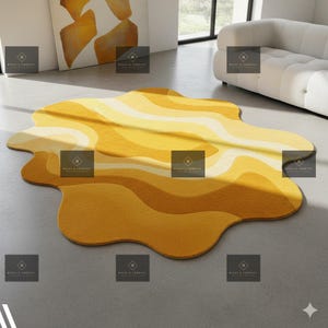 May include: A contemporary rug with an abstract design in yellow and cream hues. The rug has an irregular, flowing shape with layered, undulating patterns. The colour scheme incorporates different shades of yellow, offering a warm and welcoming feel for any room.