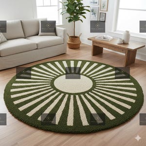 May include: A round green and cream-colored rug with a sunburst design. The rug features a central cream-colored circle, surrounded by green and cream-colored stripes radiating outwards. The rug is placed on a wooden floor in a living room setting.