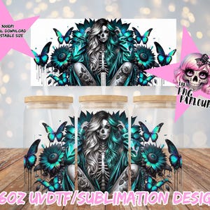 May include: Three glass jars with wooden lids, each featuring a teal and black design of a skeleton woman surrounded by butterflies and flowers. The jars have the text "16oz UVDTF/SUBLIMATION DESIGN".