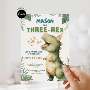 May include: A birthday party invitation with a watercolour illustration of a smiling green dinosaur wearing a party hat. The invitation reads "MASON is a THREE-REX" with party details. The invitation is held by a person.