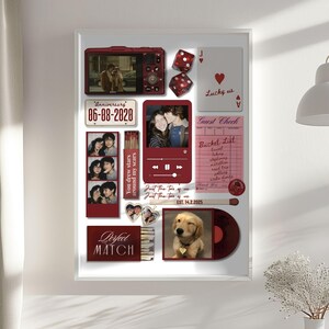 May include: A framed collage featuring various red-toned elements. Includes photos, a digital camera, dice, playing card, and a vinyl record. Text elements include "Anniversary 06-08-2020", "Lucky us", "Perfect Match", and "Guest Check".