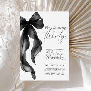 May include: A white invitation card with a black bow and the text "Flirty & thriving at thirty." The invitation is for Olivia's 30th birthday, with the date, time, and location details. The card also includes an RSVP request.