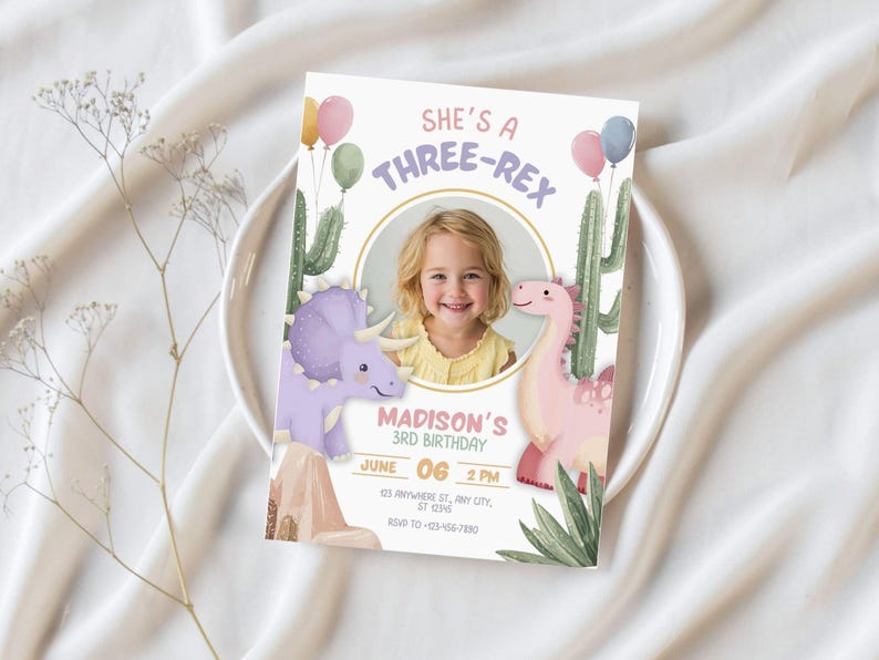 May include: A birthday invitation with the text "She's a Three-Rex" and a photo of a young girl. The invitation features illustrations of dinosaurs, cacti, and balloons. The date and time of the party are also included.