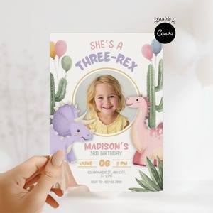 May include: A birthday invitation with the text "She's a Three-Rex" and a photo of a young girl. The invitation features illustrations of a purple Triceratops, a pink dinosaur, balloons, and cacti. The date and time of the party are also included.